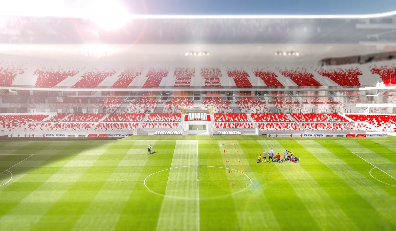 Perspective aérienne au sein du stade, aligné sur la ligne du centre du terrain, une équipe s'entraine