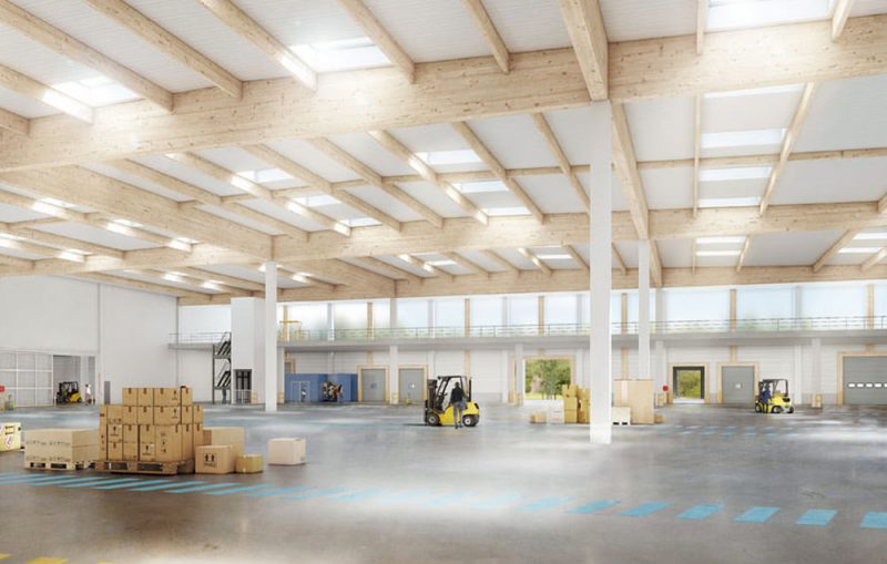 Perspective d'intérieur du grand hangar avec ses longues poutres et puits de lumières