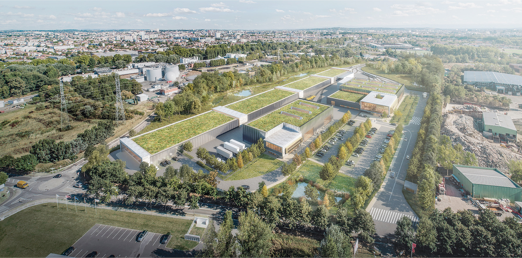 Perspective 3D aérienne de l'ensemble du projet, toiture végétalisé et trés grande longueur du bâtiment ou entrent les rails du tram, l'usine de méthanisation Ginestous Toulouse en arrière plan